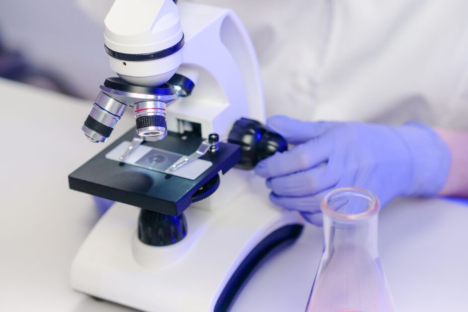 Close-up of a scientist examining slides in a modern lab.